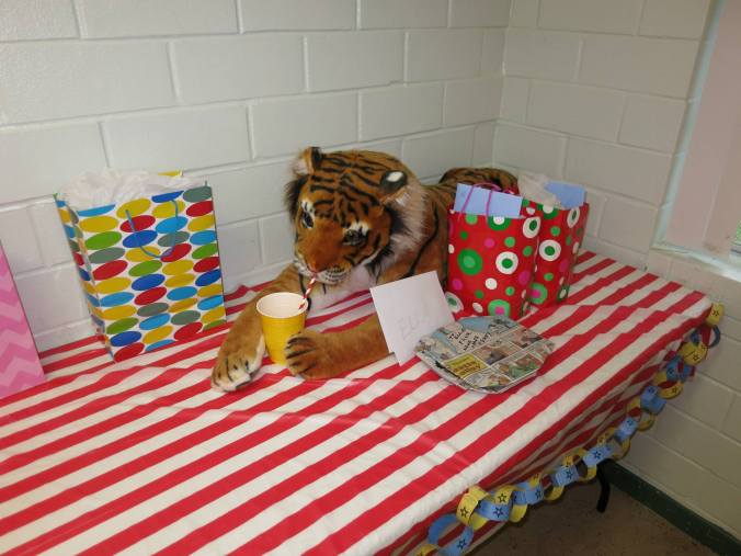 A big stuffed tiger guarded the gift table while grabbing a drink